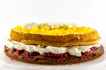Homemade pastries, colorful cake, raspberries, peaches, whipped cream