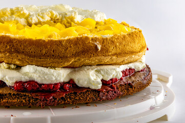 Homemade pastries, colorful cake, raspberries, peaches, whipped cream