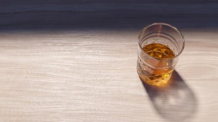 Crystal glass of whisky on a wooden table in sunlight, casting a long shadow, exuding a warm and inviting atmosphere ideal for relaxation