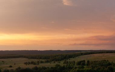 Vibrant sunset illuminates the rolling hills of Sviyazhsk, creating a serene atmosphere filled with golden colors.
