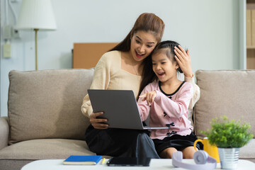 Fototapeta premium Mother and daughter spend their holiday in the living room at home.