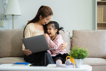 Mother and daughter spend their holiday in the living room at home.