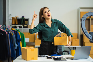 Successful Woman online seller. woman holding parcels box and looking to camera.