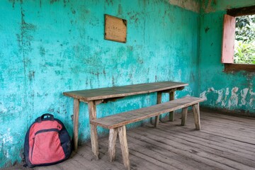 A classroom during recess, with desks slightly askew, a forgotten backpack, and a teacher tidying up