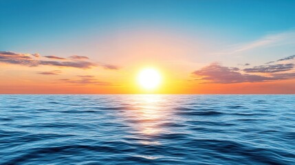 Obraz premium Vibrant sunset over tranquil ocean waters, reflecting warm colors in a serene landscape image.