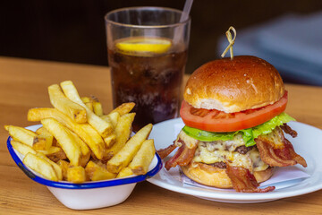 Delicious Bacon Cheeseburger with Fries and a Refreshing Soda Drink