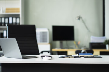 Workspace area with laptop tablet smartphone and paperwork on the table in the office concept.