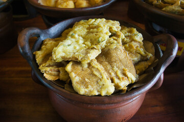 Traditional Indonesian Tempeh Fritters Served in Rustic Clay Pot