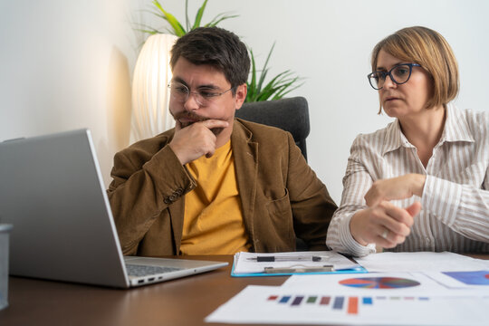 Team work process. Photo thoughtful business crew working with new startup project laptop. Project managers meeting. Analyze plans, papers. 