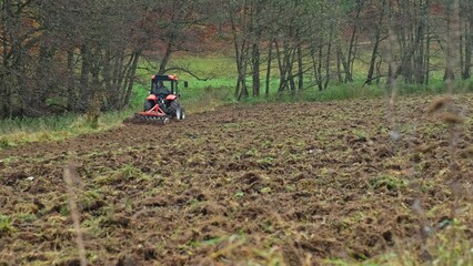 Agriculture Farming Tractor with Attached Disc Harrow used for Surface Tillage after Harvest Season to Improve Soil Structure Tilth before Planting Seeds