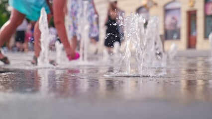 Happy Caucasian Kids Playing in City Square Piazza Pavement Flat Fountain Water Jets on Hot Summer Day