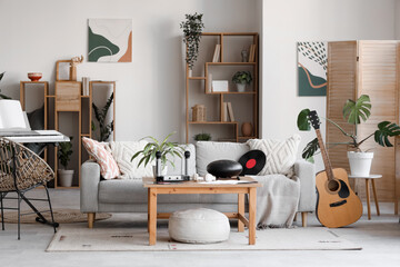 Interior of living room with sofa, table and musical instruments