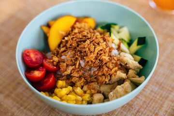 Hawaiian poke bowl with chicken, fruit and vegetables