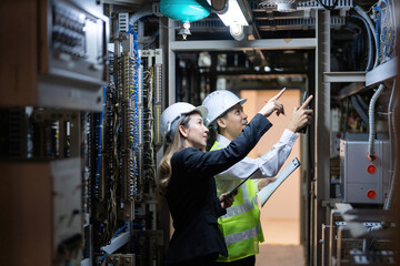 Asian male and female engineers are transforming the energy industry by designing advanced electrical circuits for power plants to sustainably power the world with their advanced knowledge and skills.