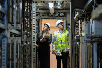 By designing intricate electrical circuits, Asian male and female engineers are revolutionizing power plants and helping the energy industry meet the world’s energy challenges.