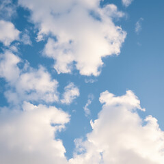 Obraz premium Low angle view of a clear blue sky and fluffy clouds in the background.