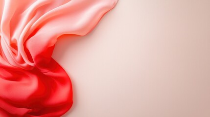 Flowing silk fabric in soft pink and red hues on neutral background
