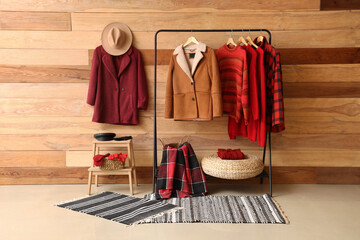 Interior of room with rack, stool and winter clothes