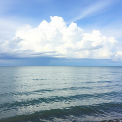 Obraz premium A calm blue sea with rolling waves and a distant island silhouetted against a cloudy sky.