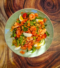 Decorative lunch plate with salad with ingredients such as crayfish and various organic vegetables such as oak leaf lettuce, rocket leaves and tomatoes, lamb's lettuce, egg flakes  cold smoked salmon