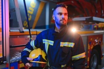 Fototapeta premium Portrait of male firefighter in uniform at fire station