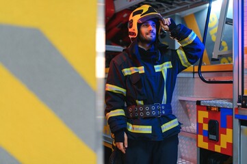 Fototapeta premium Portrait of male firefighter in uniform at fire station