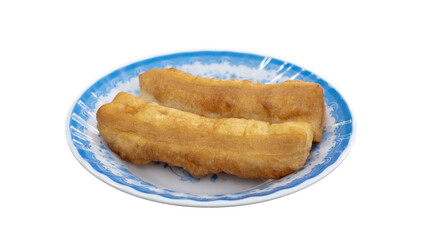 Deep fried dough stick on white dish. Youtiao or Yu Char Kway. Quay. Fried bread stick or popularly known as You Tiao.