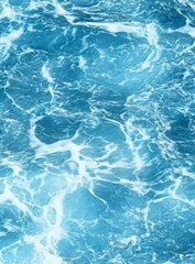 Obraz premium Calm ocean surface with gently lapping waves in shades of blue and white, creating a serene and dynamic background for underwater scenes.