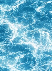 Fototapeta premium Calm ocean surface with gently lapping waves in shades of blue and white, creating a serene and dynamic background for underwater scenes.