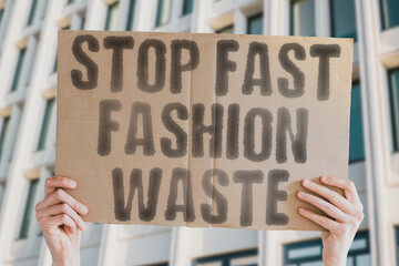 A cardboard banner reads 'Stop fast fashion waste,' advocating for sustainable choices and reducing pollution. Sustainability. Textiles. Pollution. Eco. Waste. Change. Ethical