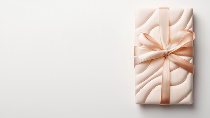 A beautifully wrapped gift in soft pink with a shimmering ribbon, perfect for celebrations and special occasions