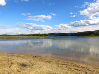 morning on the sandy shore of a quiet lake