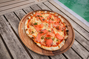 High angle, Pizza with salmon place on wooden tray