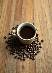 Wooden table with a cup of coffee and scattered coffee beans , beans, table, wood