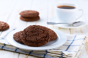 American chocolate cookies and coffee on a light kitchen table, selective focus.