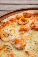 Close up, Pizza with Tom Yum seafood place on wooden tray