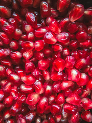 pomegranate grains scattered on the table top view close-up