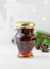 Jam from cones in a beautiful glass jar. A fragrant winter delicacy