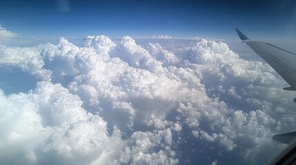 Fototapeta premium Serene View of Puffy Clouds from Airplane Window at High Altitude