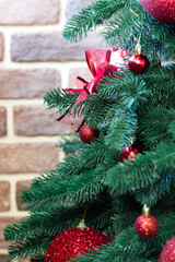Christmas tree decorated with red balls and bells. Christmas. Festive Interior