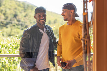 Two African American LGBT gay men on vacations at glamping resort. Tourism, traveling, and experience concepts.