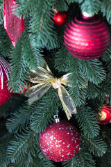 Red Christmas ball on a Christmas tree. Christmas tree. Festive interior