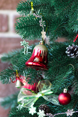 Red bells on a Christmas tree. Christmas tree. Festive atmosphere