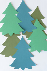 layered blank flat machine-cut paper tree shapes on blank paper