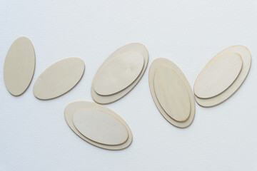 laser-cut wooden ovoid shapes arranged on blank paper