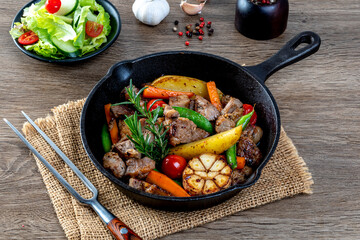 meat stew with mixed vegetables in a hot plate.