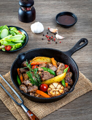 meat stew with mixed vegetables in a hot plate.