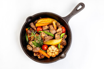 meat stew with mixed vegetables in a hot plate isolated on white background.