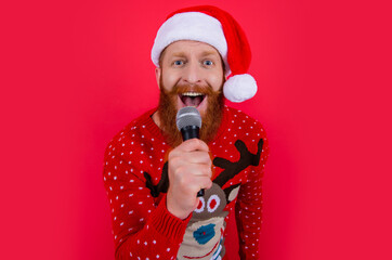christmas music party. amazed man at christmas music party with microphone. christmas santa man