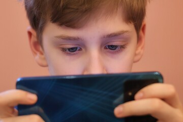 Close-up of a teenager's eyes staring at a smartphone
